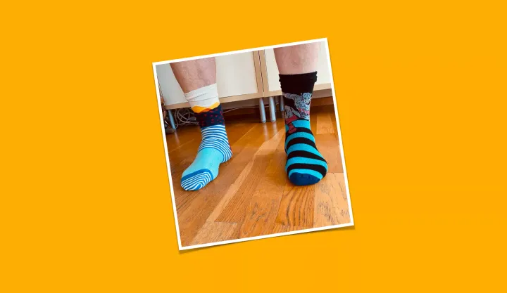 A picture of my socks. They are colorful, striped and do not match.